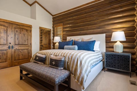 Settle into serene sleep with soft lighting and rustic walls.
