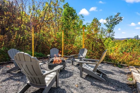 Cozy outdoor fire pit area with chairs, perfect for relaxing under the stars. Enjoy peaceful mountain views, crisp evening air, and unforgettable moments with family and friends in this serene Smoky Mountain retreat!
