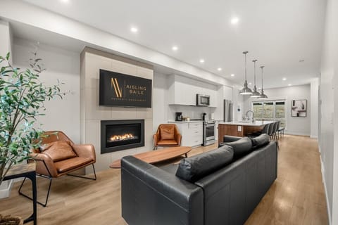 Living room on the main floor with a gas fireplace, Smart TV, cozy seating and walkout access to the balcony/hot tub.