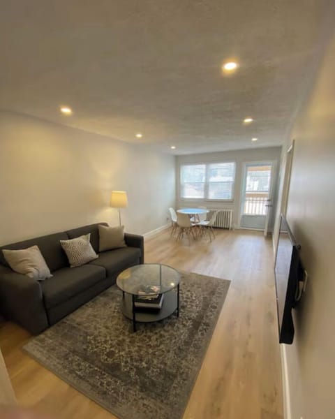 Living room with dining area that seats 4. Door to private balcony.