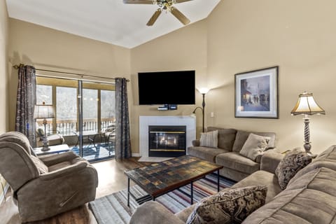 Bright & Clean Living Room has electric fireplace and views of the lake. 