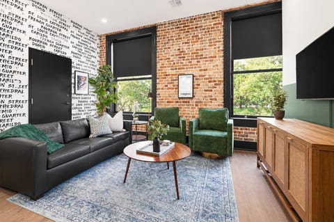 Relax in the living area with a smart TV, stylish seating, and a sleeper sofa for extra guests. Perfect for families or group stays in New Orleans, this inviting space is ideal for movie nights or recharging after a day in the city.