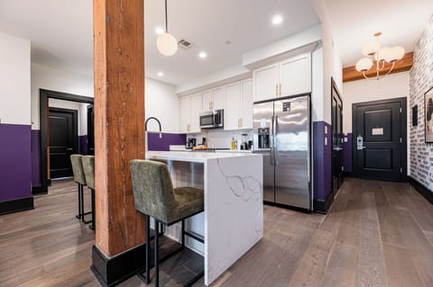 Cook or snack in style with a full kitchen featuring GE stainless appliances, cookware, and an island with bar seating. Ideal for short or extended stays, our kitchens make group travel in New Orleans easy and comfortable.