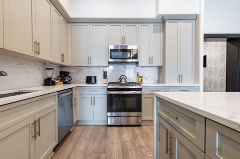 Cook or snack in style with a full kitchen featuring GE stainless appliances, cookware, and an island with bar seating. Ideal for short or extended stays, our kitchens make group travel in New Orleans easy and comfortable.