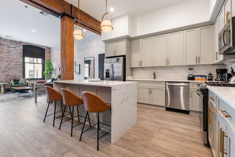 Cook or snack in style with a full kitchen featuring GE stainless appliances, cookware, and an island with bar seating. Ideal for short or extended stays, our kitchens make group travel in New Orleans easy and comfortable.