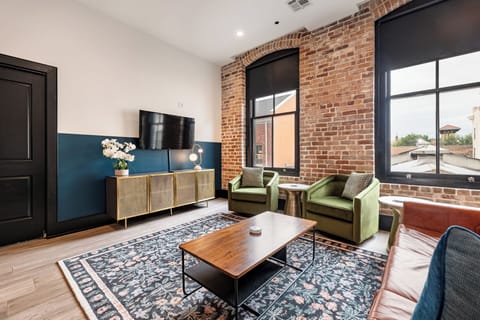 Relax in the living area with a smart TV, stylish seating, and a queen-sized sleeper sofa for extra guests. Perfect for families or group stays in New Orleans, this inviting space is ideal for movie nights or recharging after a day in the city.