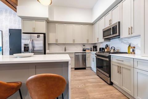 Cook or snack in style with a full kitchen featuring GE stainless appliances, cookware, and an island with bar seating. Ideal for short or extended stays, our kitchens make group travel in New Orleans easy and comfortable.