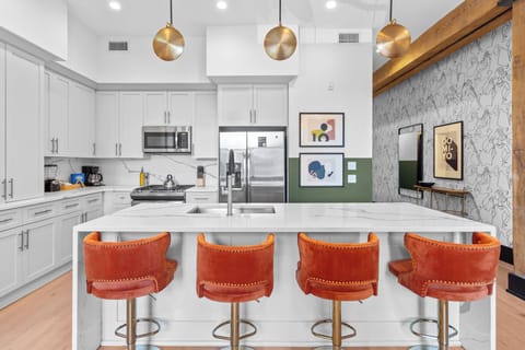 Cook or snack in style with a full kitchen featuring GE stainless appliances, cookware, and an island with bar seating. Ideal for short or extended stays, our kitchens make group travel in New Orleans easy and comfortable.