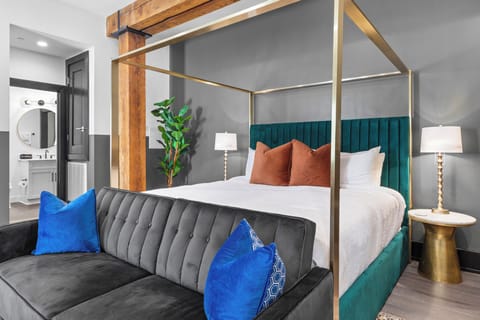 Retreat to the sleeping area with a plush king bed, blackout shades, and a smart TV.