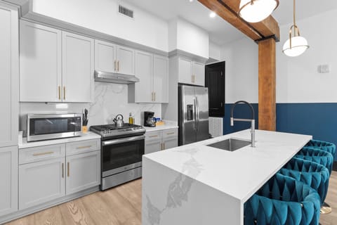 Cook or snack in style with a full kitchen featuring GE stainless appliances, cookware, and an island with bar seating. Ideal for short or extended stays, our kitchens make group travel in New Orleans easy and comfortable.