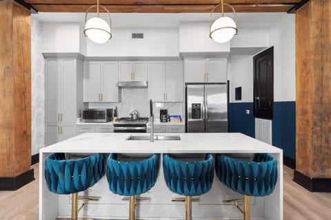 Cook or snack in style with a full kitchen featuring GE stainless appliances, cookware, and an island with bar seating. Ideal for short or extended stays, our kitchens make group travel in New Orleans easy and comfortable.