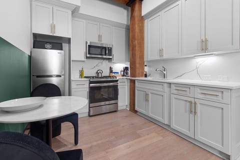 Cook or snack in style with a full kitchen featuring GE stainless appliances, cookware, and an island with bar seating. Ideal for short or extended stays, our kitchens make group travel in New Orleans easy and comfortable.