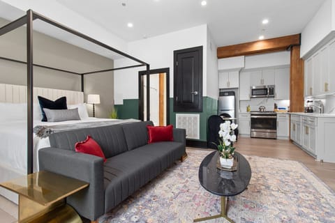 Relax in the studio living area with a smart TV, stylish seating, king-sized bed and a futon for extra guest. This inviting space is ideal for movie nights or recharging after a day in the city.