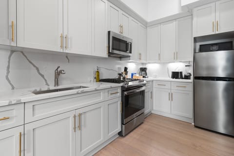Cook or snack in style with a full kitchen featuring GE stainless appliances, cookware, and an island with bar seating. Ideal for short or extended stays, our kitchens make group travel in New Orleans easy and comfortable.