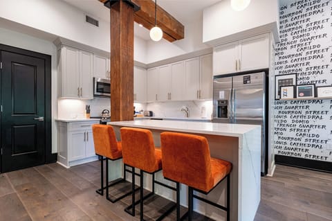 Cook or snack in style with a full kitchen featuring GE stainless appliances, cookware, and an island with bar seating. Ideal for short or extended stays, our kitchens make group travel in New Orleans easy and comfortable.