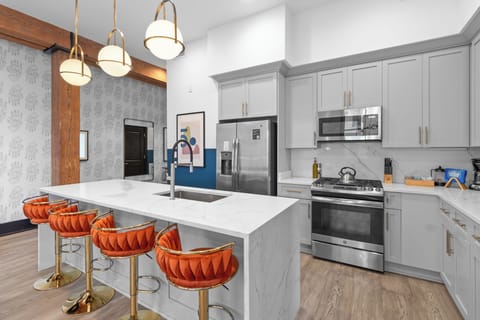 Cook or snack in style with a full kitchen featuring GE stainless appliances, cookware, and an island with bar seating. Ideal for short or extended stays, our kitchens make group travel in New Orleans easy and comfortable.