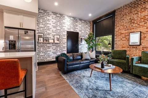 Relax in the living area with a smart TV, stylish seating, and a sleeper sofa for extra guests. Perfect for families or group stays in New Orleans, this inviting space is ideal for movie nights or recharging after a day in the city.