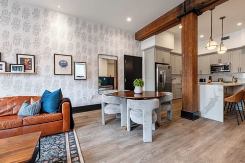 Enjoy meals together at your in-suite dining table with seating for your group. Whether it's takeout, delivery, or a home-cooked meal, this cozy dining area makes every stay at 888 Baronne feel like home in New Orleans.