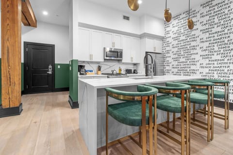 Cook or snack in style with a full kitchen featuring GE stainless appliances, cookware, and an island with bar seating. Ideal for short or extended stays, our kitchens make group travel in New Orleans easy and comfortable.