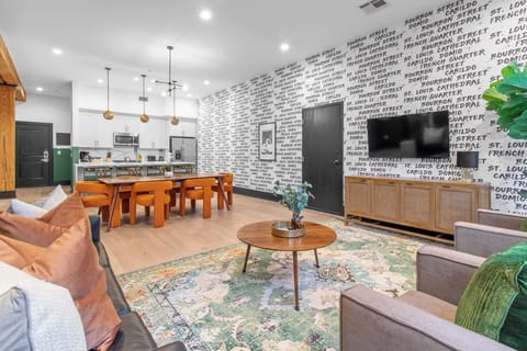 Relax in the living area with a smart TV, stylish seating, and a queen-size sleeper sofa for extra guests. Perfect for families or group stays in New Orleans, this inviting space is ideal for movie nights or recharging after a day in the city.
