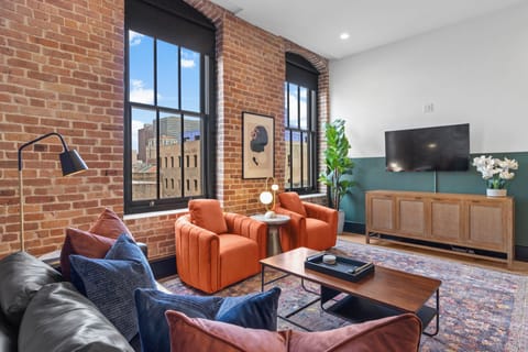 Relax in the living area with a smart TV, stylish seating, and a sleeper sofa for extra guests. Perfect for families or group stays in New Orleans, this inviting space is ideal for movie nights or recharging after a day in the city.