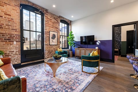Relax in the living area with a smart TV, stylish seating, and a sleeper sofa for extra guests. Perfect for families or group stays in New Orleans, this inviting space is ideal for movie nights or recharging after a day in the city.