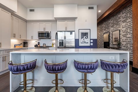 Cook or snack in style with a full kitchen featuring GE stainless appliances, cookware, and an island with bar seating. Ideal for short or extended stays, our kitchens make group travel in New Orleans easy and comfortable.