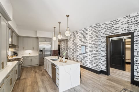 Cook or snack in style with a full kitchen featuring GE stainless appliances, cookware, and an island with bar seating. Ideal for short or extended stays, our kitchens make group travel in New Orleans easy and comfortable.