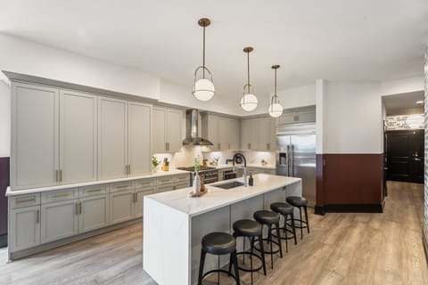 Cook or snack in style with a full kitchen featuring GE stainless appliances, cookware, and an island with bar seating. Ideal for short or extended stays, our kitchens make group travel in New Orleans easy and comfortable.