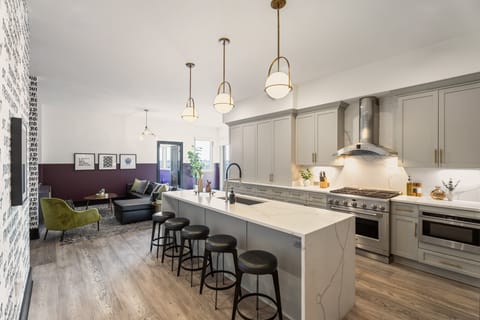 Cook or snack in style with a full kitchen featuring GE stainless appliances, cookware, and an island with bar seating. Ideal for short or extended stays, our kitchens make group travel in New Orleans easy and comfortable.