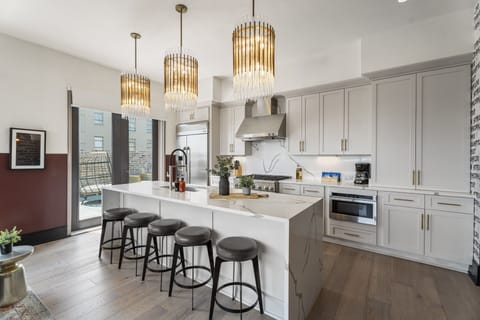 Cook or snack in style with a full kitchen featuring GE stainless appliances, cookware, and an island with bar seating. Ideal for short or extended stays, our kitchens make group travel in New Orleans easy and comfortable.