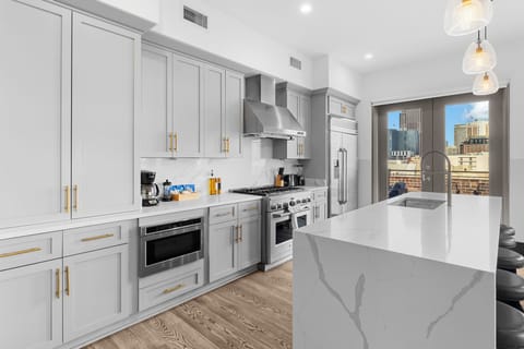 Cook or snack in style with a full kitchen featuring GE stainless appliances, cookware, and an island with bar seating. Ideal for short or extended stays, our kitchens make group travel in New Orleans easy and comfortable.