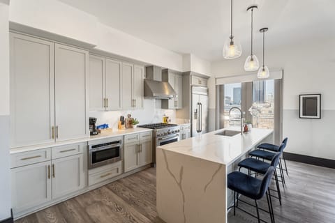 Cook or snack in style with a full kitchen featuring GE stainless appliances, cookware, and an island with bar seating. Ideal for short or extended stays, our kitchens make group travel in New Orleans easy and comfortable.