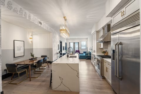 Cook or snack in style with a full kitchen featuring GE stainless appliances, cookware, and an island with bar seating. Ideal for short or extended stays, our kitchens make group travel in New Orleans easy and comfortable.