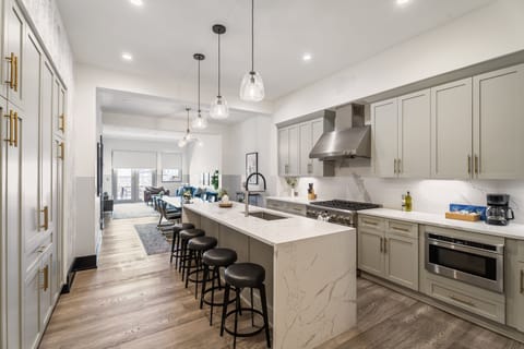 Cook or snack in style with a full kitchen featuring GE stainless appliances, cookware, and an island with bar seating. Ideal for short or extended stays, our kitchens make group travel in New Orleans easy and comfortable.