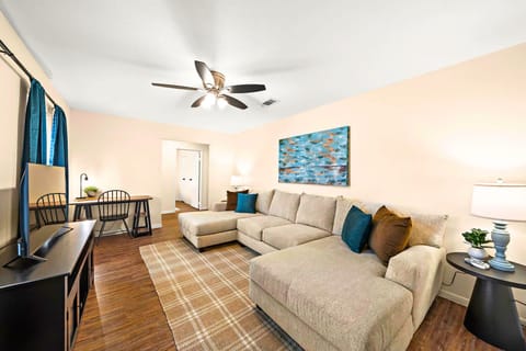 Living Room Retreat: Bright space with comfy sectional and artistic flair—perfect for unwinding!