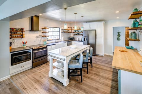 The updated, spacious kitchen boasts modern appliances, ample counter space, and a sleek design perfect for cooking and entertaining.