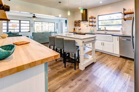 The open kitchen creates a seamless flow between the kitchen, dining, and living areas, perfect for entertaining and easy interaction while cooking.