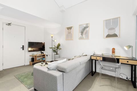 Enjoy our open living space with a comfortable sofa and a designated work area.