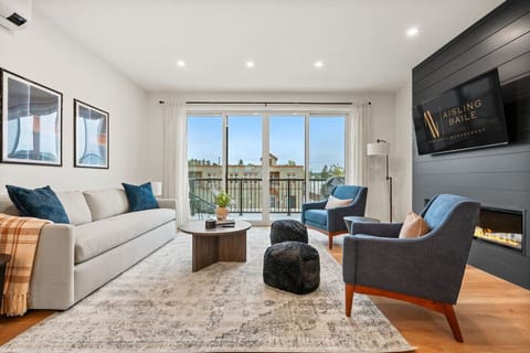 Main living room (located on the 2nd floor) with a fireplace feature, Smart TV, cozy seating & access to the balcony`s BBQ (propane`s on us!)