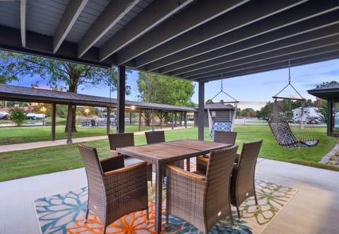 Enjoy al fresco dining on the covered patio, complete with a spacious table and comfortable seating.