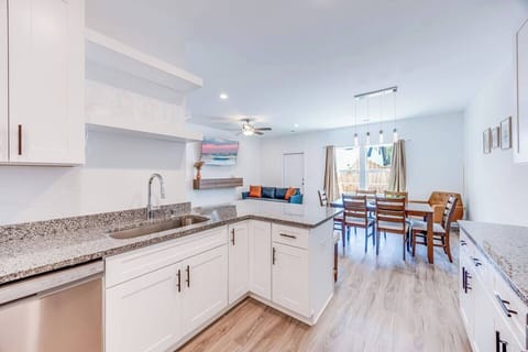 Modern and open, this brand-new kitchen with stainless steel appliances overlooks the dining and living areas, featuring big windows that fill the space with natural light.