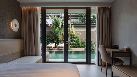 Deluxe Corner Pool Access | Minibar, in-room safe, desk, blackout drapes