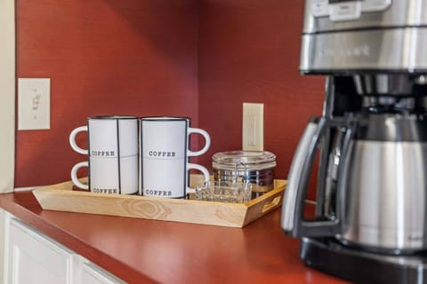 Ground coffee is provided with a drip coffee maker. There are also fun cafes a few blocks away downtown.