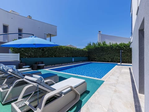 Building, Swimming Pool, Sky, Plant, Water, Azure, Outdoor Furniture, Shade, Window, Sunlounger