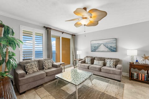 Relax in this modern living room with ocean views through large windows.