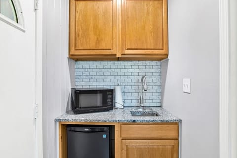 Cozy master kitchenette, perfect for quick meals and snacks, featuring all the essentials in a compact and convenient space.