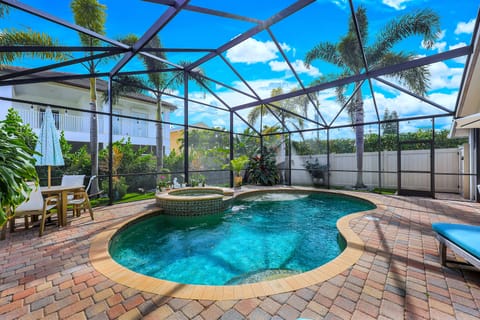 Pool with a lanai screen enclosure.