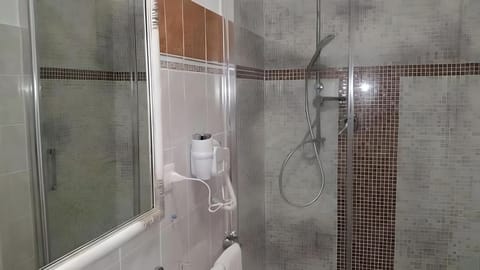 Shower, hair dryer, slippers, towels