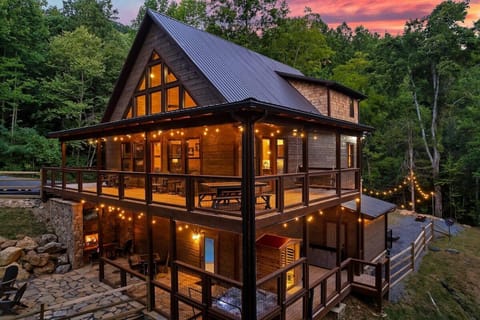 Three stories of wraparound decks, string lights on every level, the hot tub glowing below, pull up to the driveway and feel twelve people's energy shift at once.